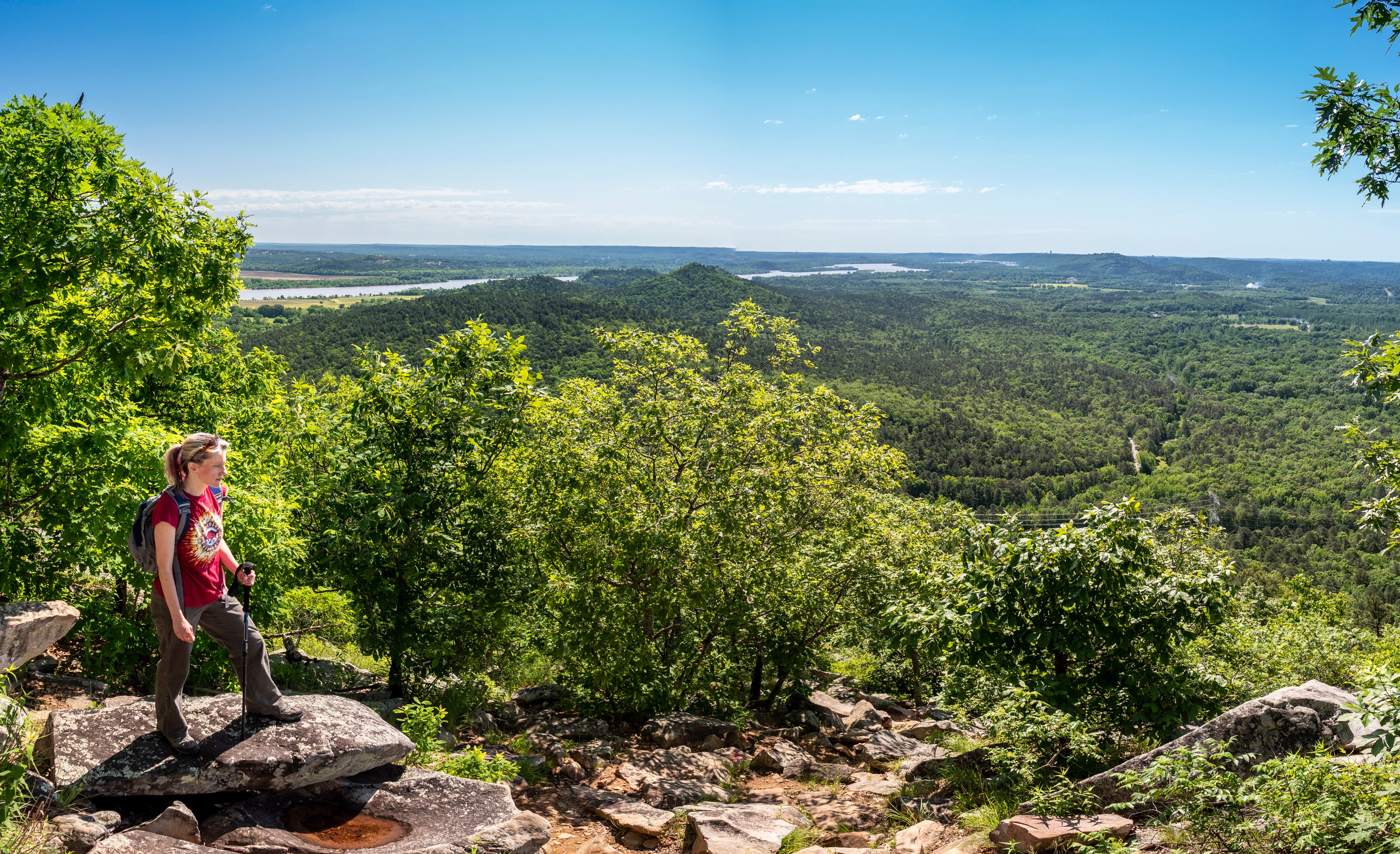 Woman hiking surrounded by trees and rocks on the East Quarry Trail